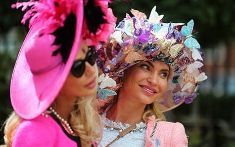 it is common for women to wear dresses, hats and heels to prestigious horse racing events