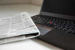 A laptop and newspaper